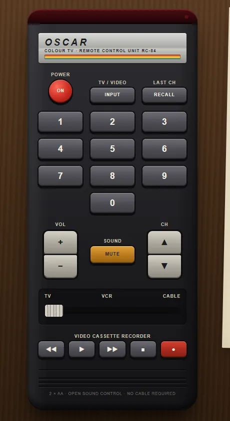 TV Remote, 1984 template: a black handset with grey rubber keys, a red power key and a rainbow stripe.